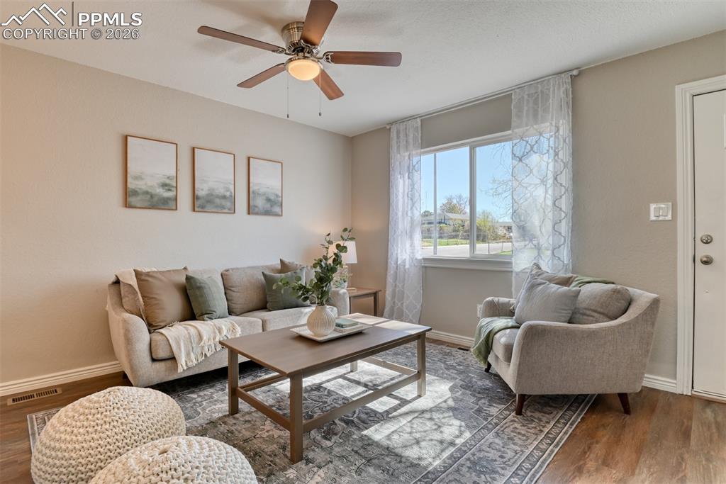 Image 8 of 39: Living room featuring a ceiling fan, recessed lighting, wood flooring, and
