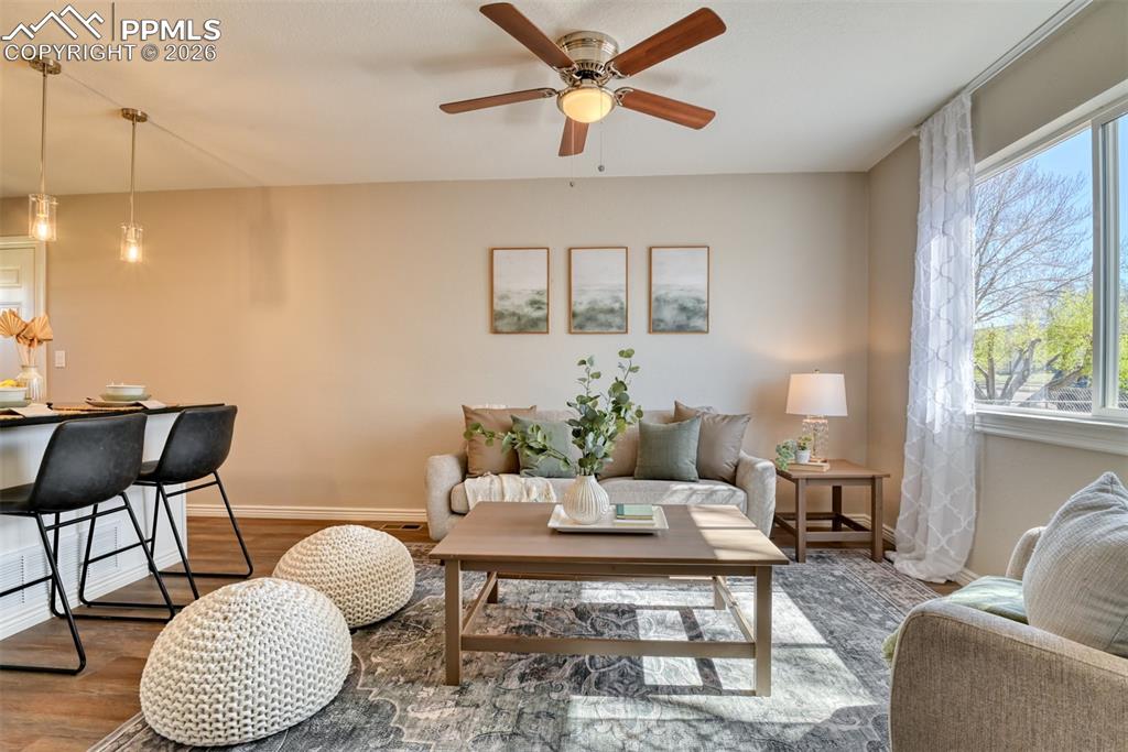 Image 9 of 39: Open concept living area featuring a ceiling fan, a window with natural lig