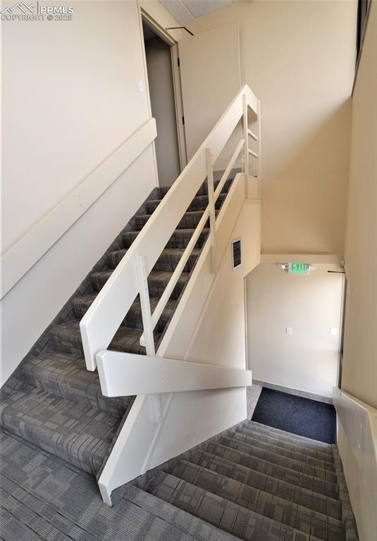 Image 13 of 16: Stairway with carpet floors
