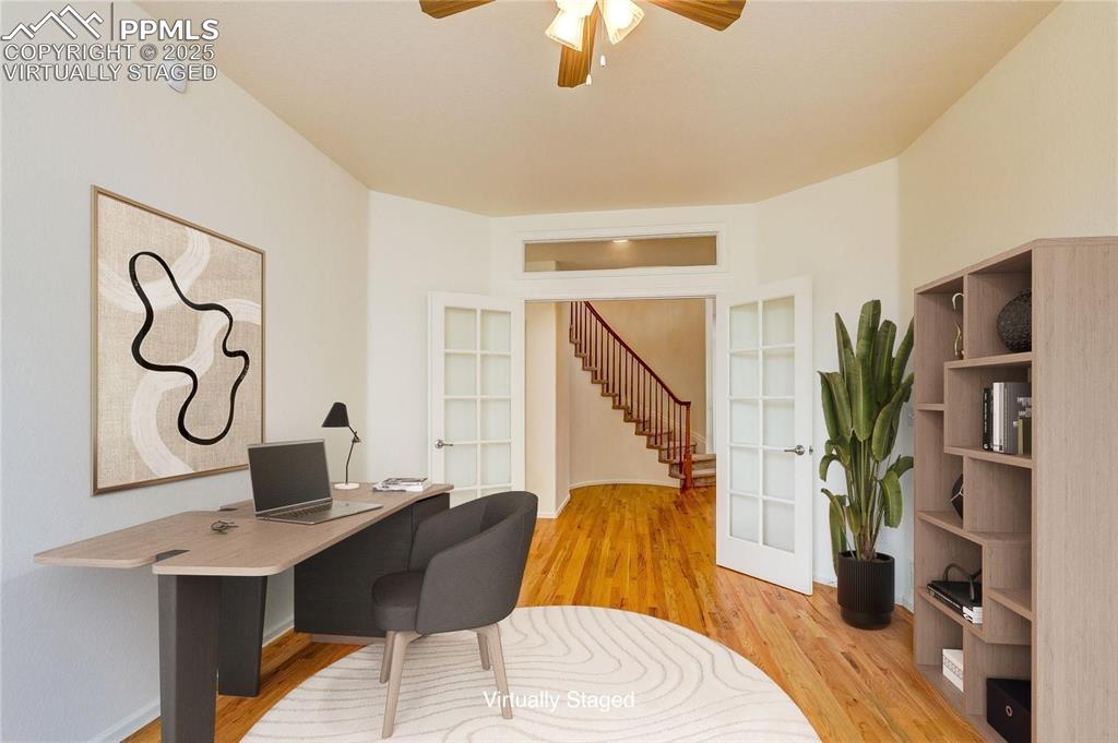 Image 18 of 50: Main level office virtually staged