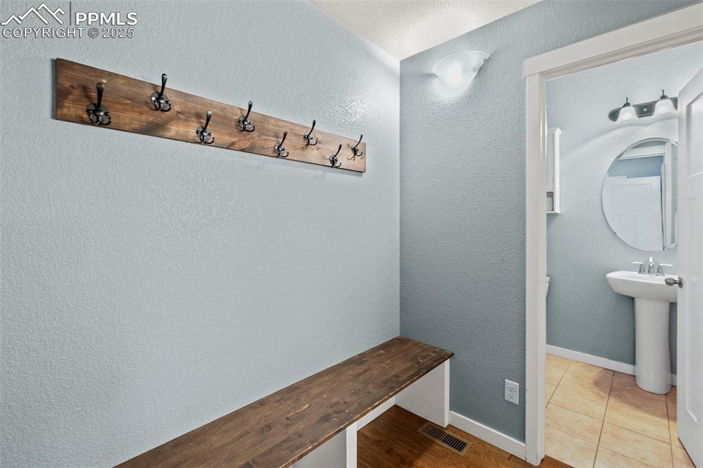 Image 14 of 31: Mudroom with a bench