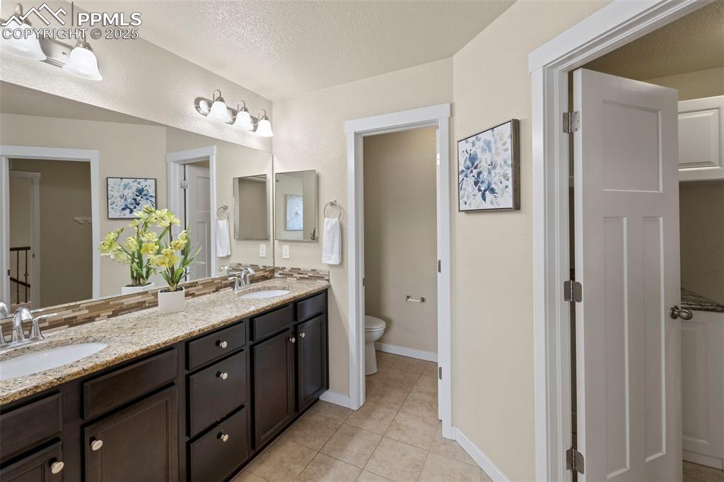 Image 20 of 31: Primary bathroom that connects the laundry room 