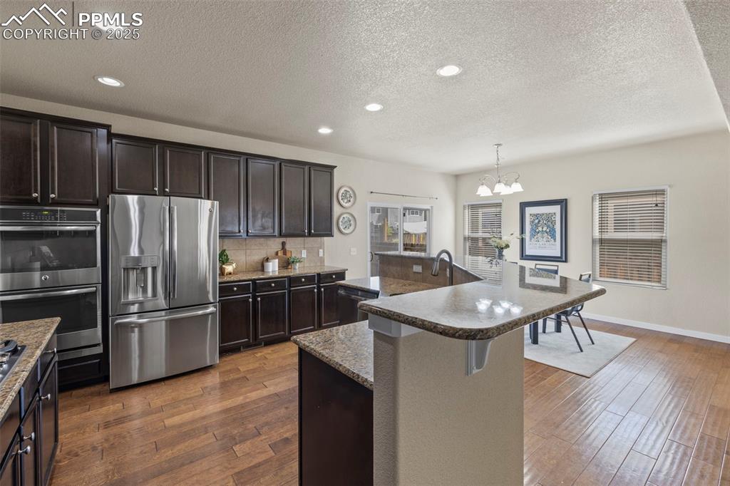 Image 3 of 31: Gourmet kitchen with stainless steel appliances, gas range, double oven and