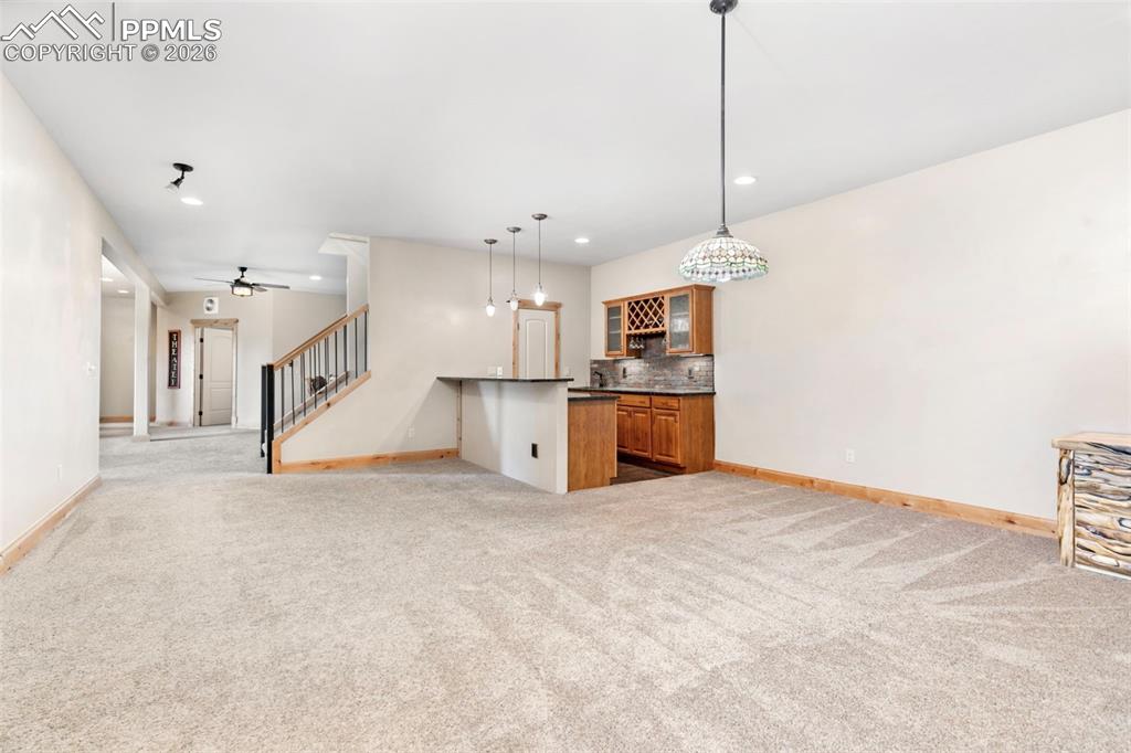 Image 36 of 48: Basement Family Room with Wet Bar