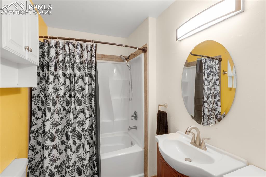 Image 15 of 39: Bathroom featuring vanity and shower / bath combo