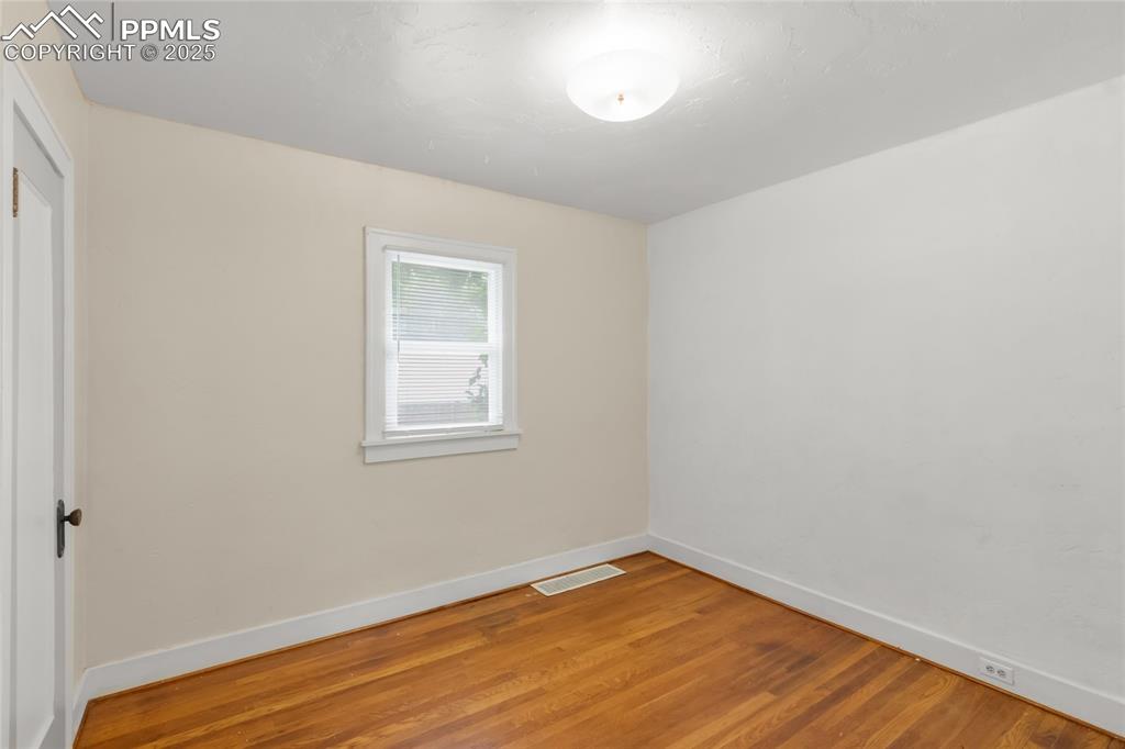 Image 17 of 39: Unfurnished room featuring baseboards and light wood-style floors