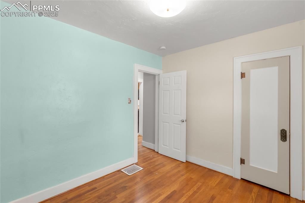 Image 18 of 39: Unfurnished bedroom featuring baseboards and wood finished floors