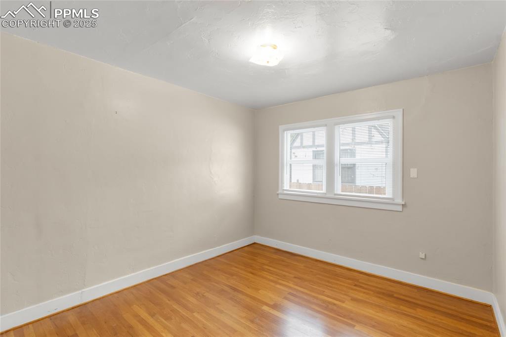 Image 20 of 39: Empty room featuring light wood-style flooring and baseboards