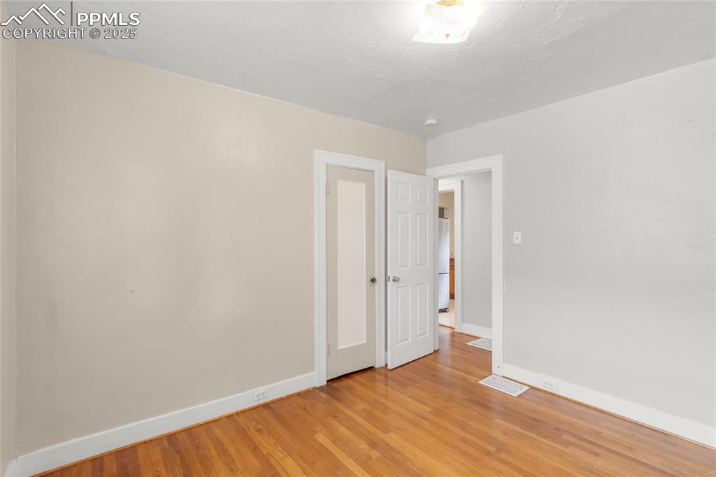 Image 21 of 39: Spare room with baseboards and light wood-type flooring