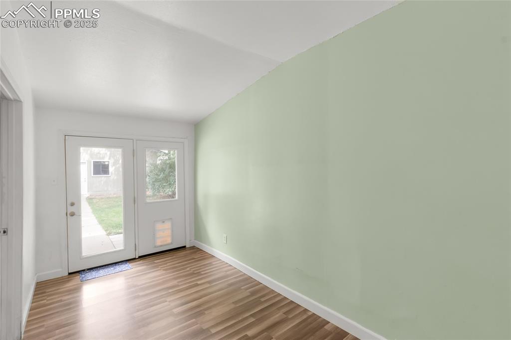 Image 25 of 39: Spare room with wood finished floors and baseboards