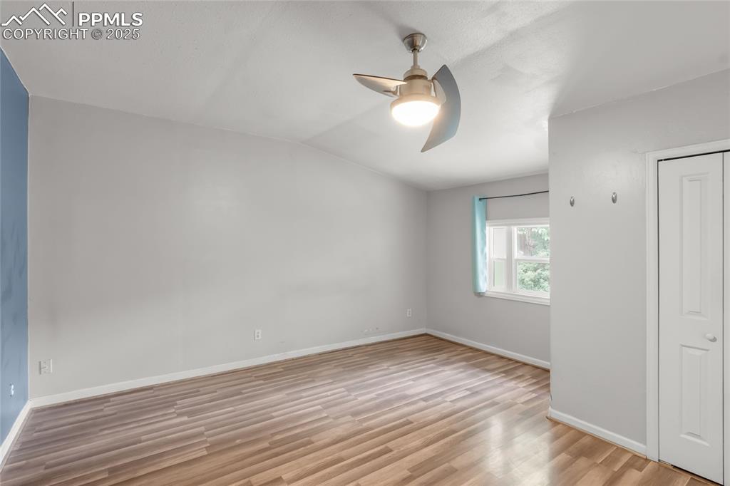 Image 28 of 39: Unfurnished bedroom with light wood-style floors, lofted ceiling, and a cei