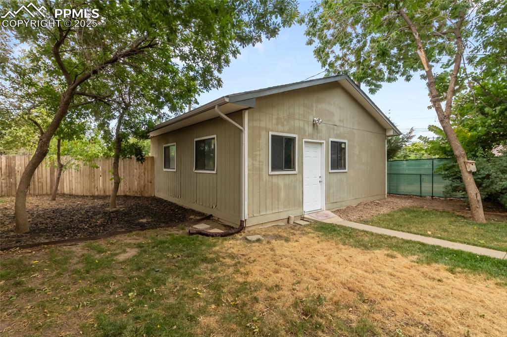 Image 31 of 39: View of outdoor structure featuring a fenced backyard