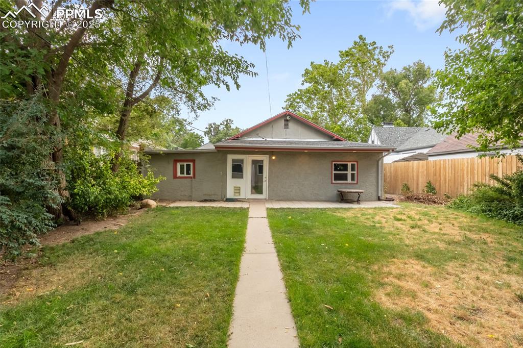 Image 38 of 39: Rear view of house with a patio and stucco siding