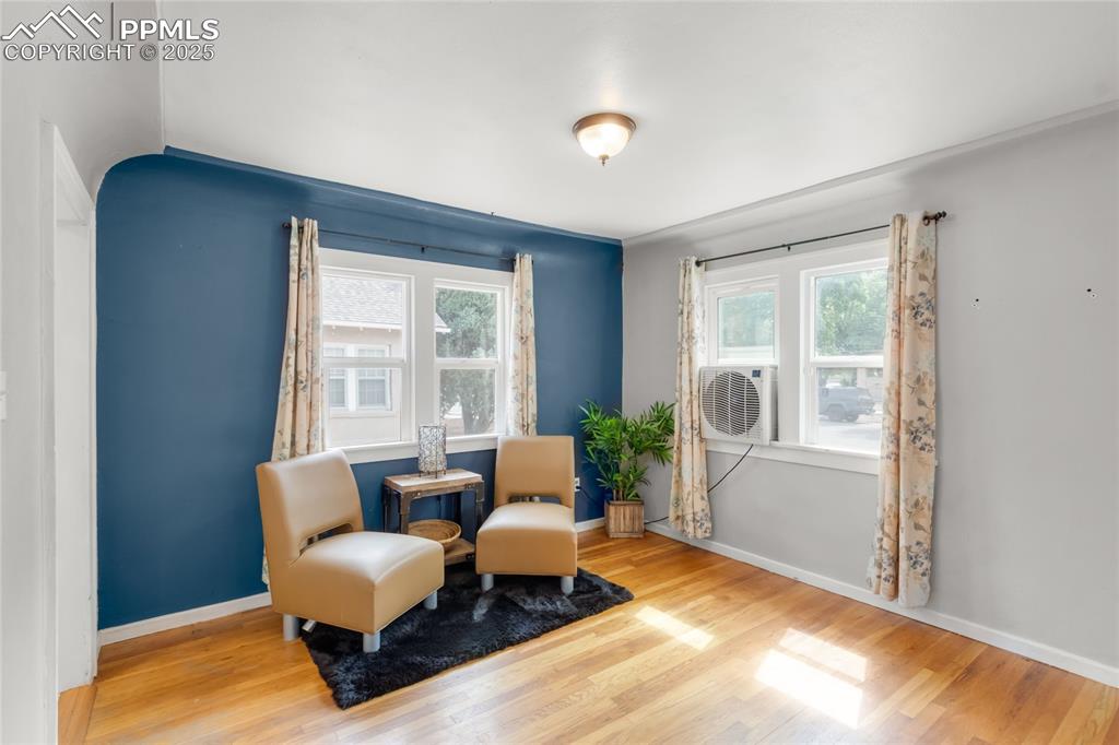 Image 7 of 39: Sitting room with wood finished floors