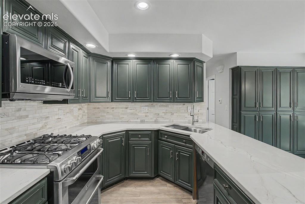 Image 10 of 49: Kitchen with Abundant Cabinetry & Counter Space
