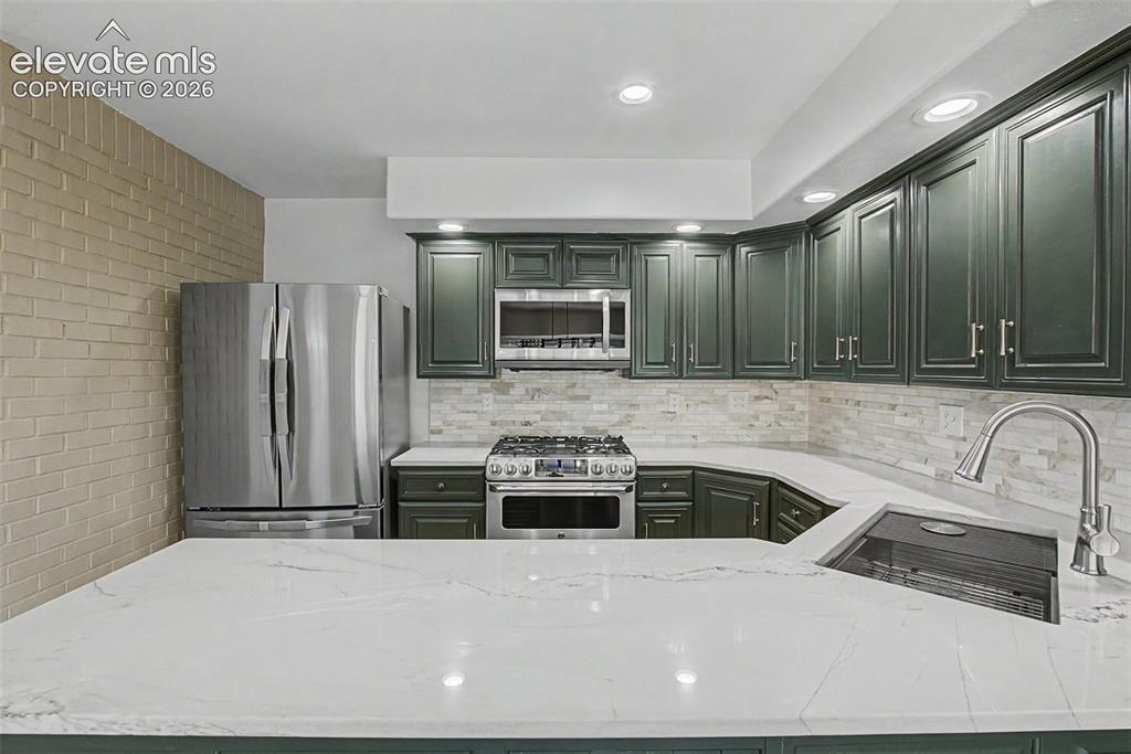 Image 11 of 49: Spacious Kitchen with Quartz Countertops