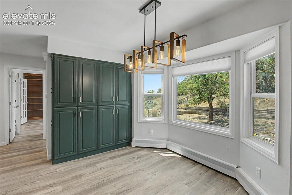 Image 12 of 49: Bright Dining Area Surrounded by Windows