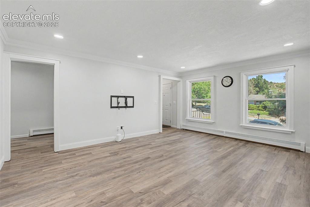 Image 17 of 49: Spacious Sitting Room with Large Windows
