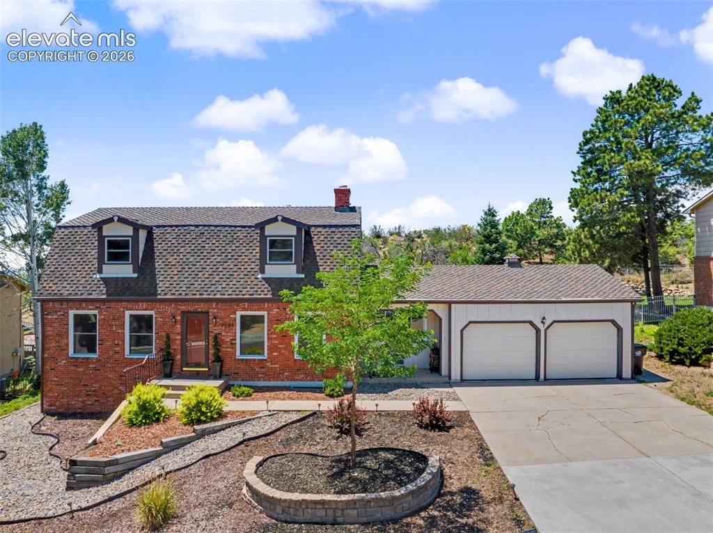 Image 2 of 49: Beautiful Front Exterior & Mature Landscaping