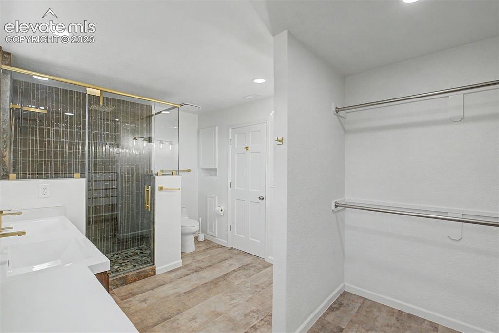 Image 25 of 49: Primary Bath with Dual Vanities and Lovely Shower