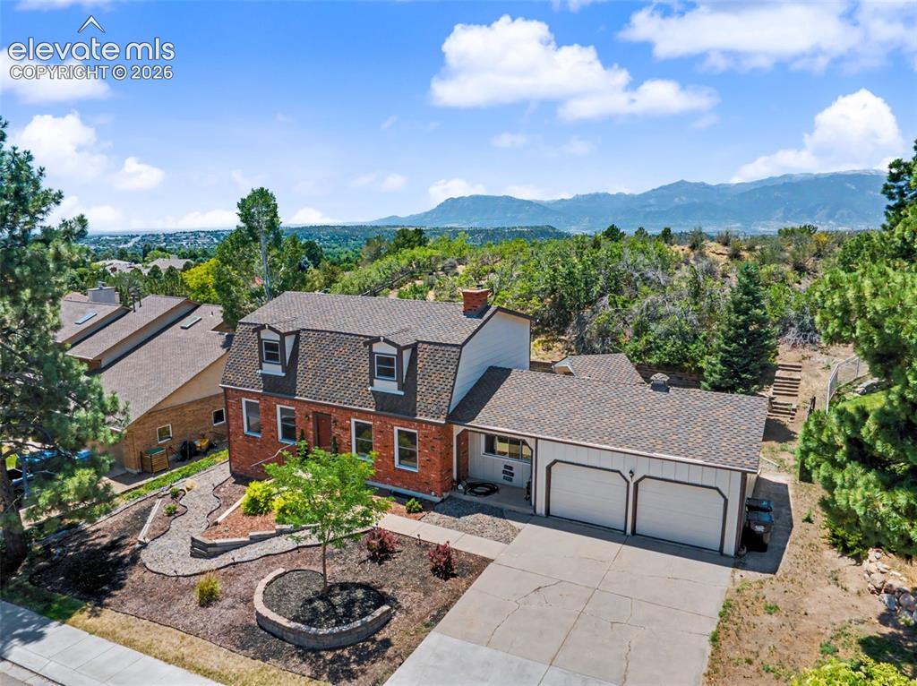 Image 3 of 49: Front Exterior & Spacious Driveway