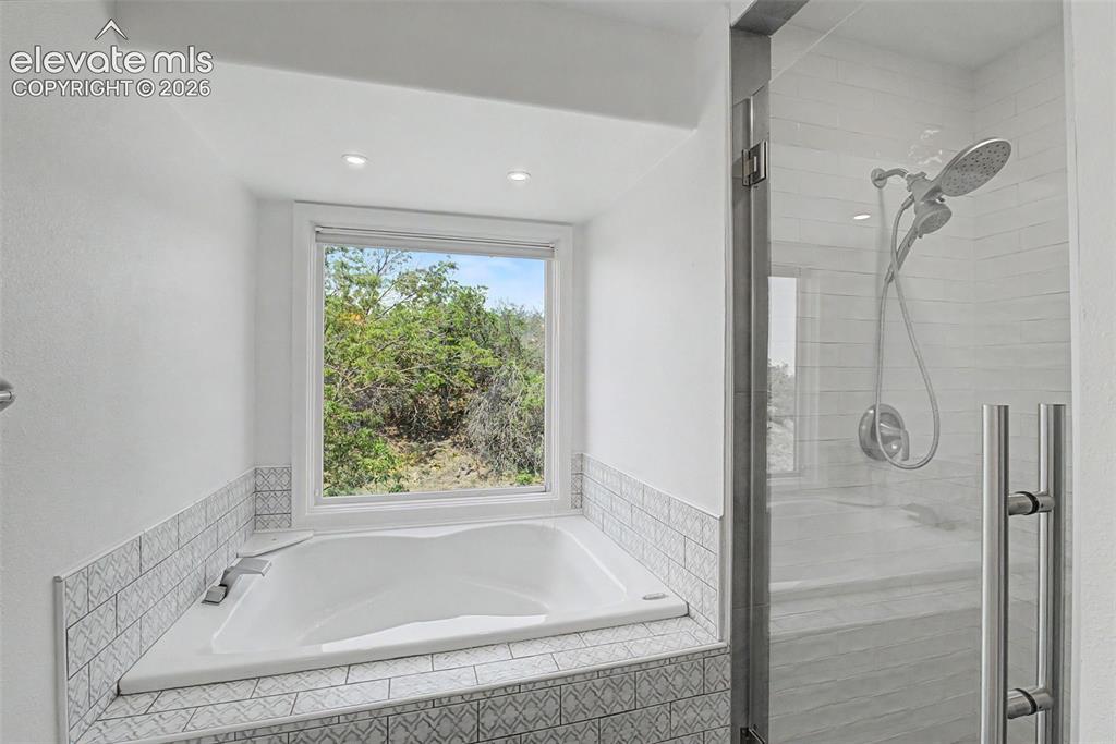 Image 32 of 49: Secondary Bath with Soaking Tub and Walk-In Shower