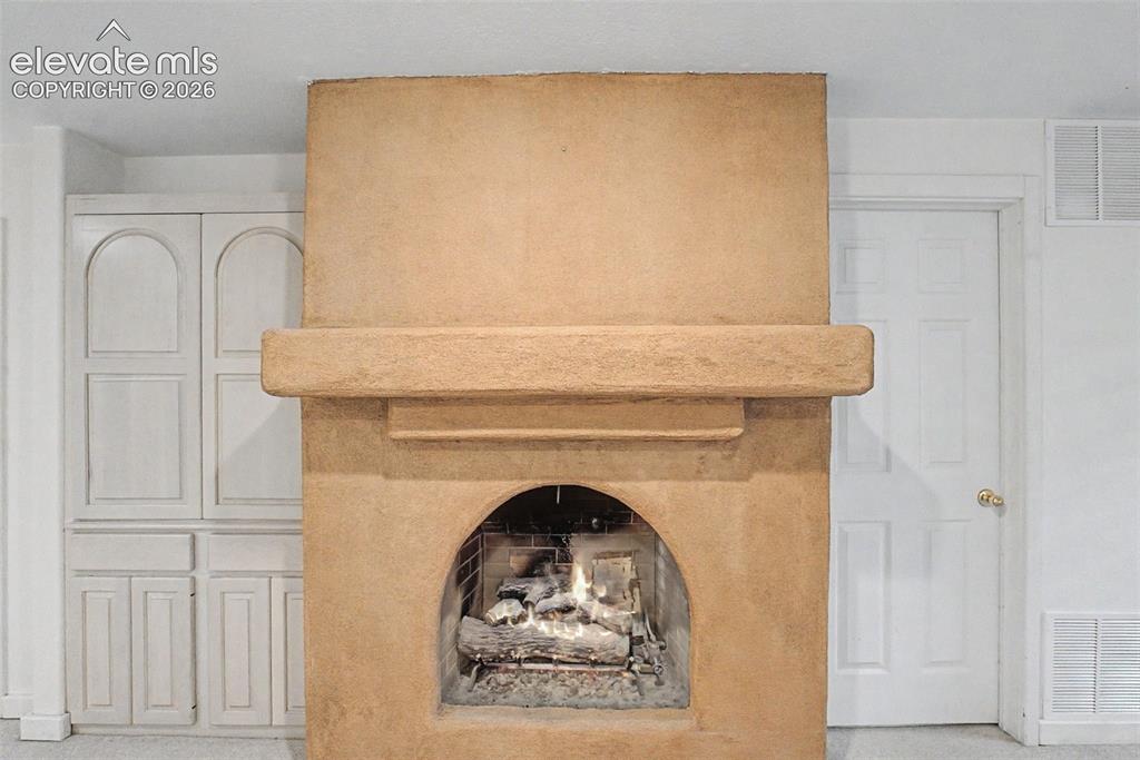 Image 39 of 49: Family Room with Wood-Burning Fireplace