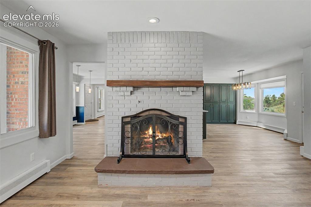 Image 8 of 49: Living Room with Cozy Fireplace