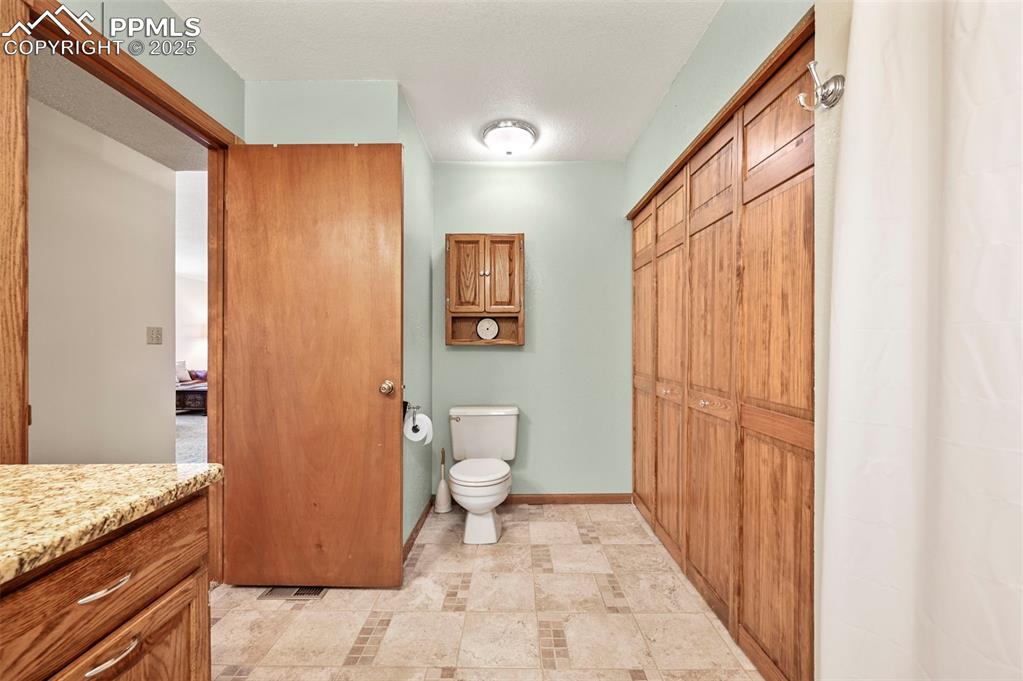 Image 18 of 32: Guest bathroom with laundry room