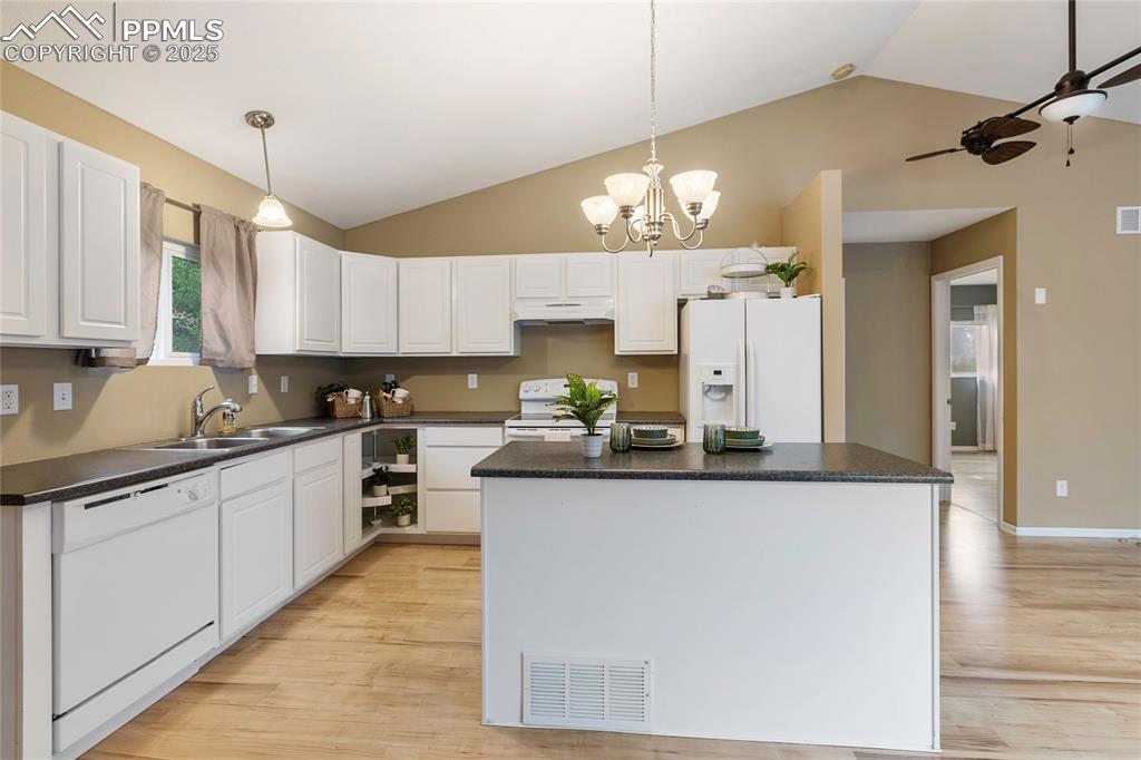 Image 12 of 27: Lots of cabinet space and a center island!