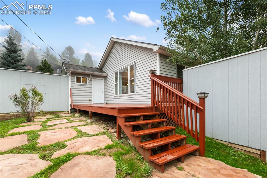 Image 3 of 27: Feel free to enjoy the fenced side yard on your way inside
