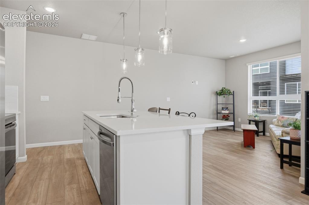 Image 11 of 24: The dishwasher is in the island next to the kitchen sink