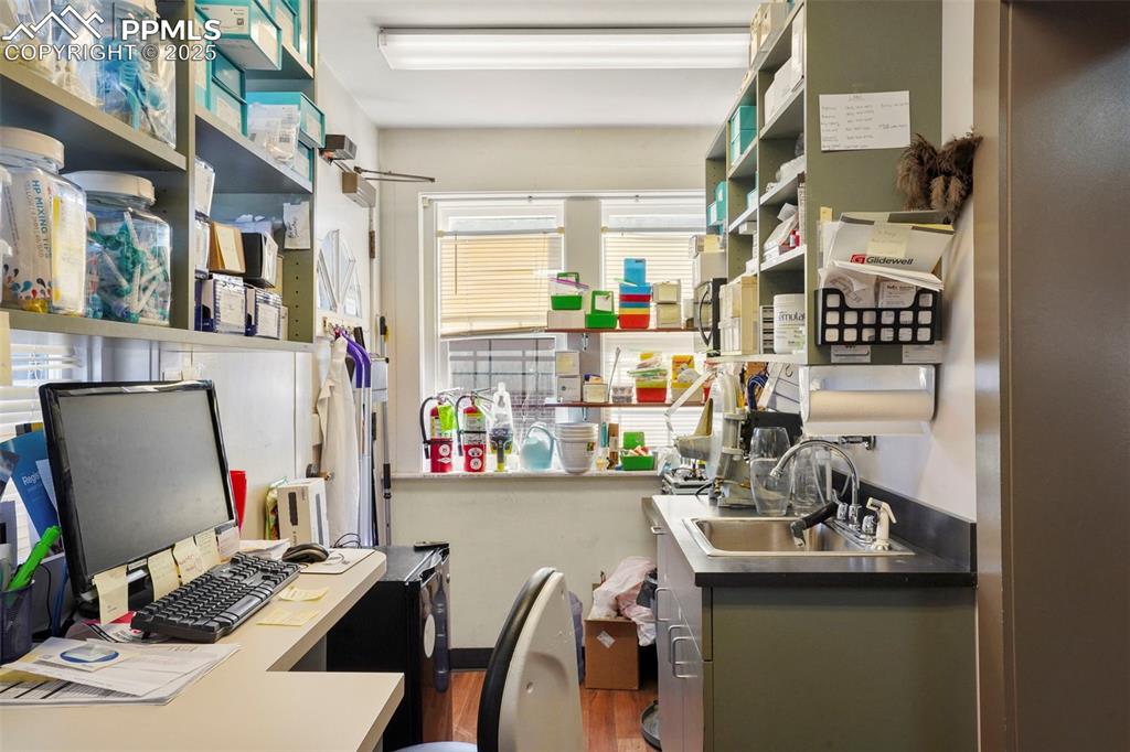 Image 11 of 28: Office featuring a sink and wood finished floors
