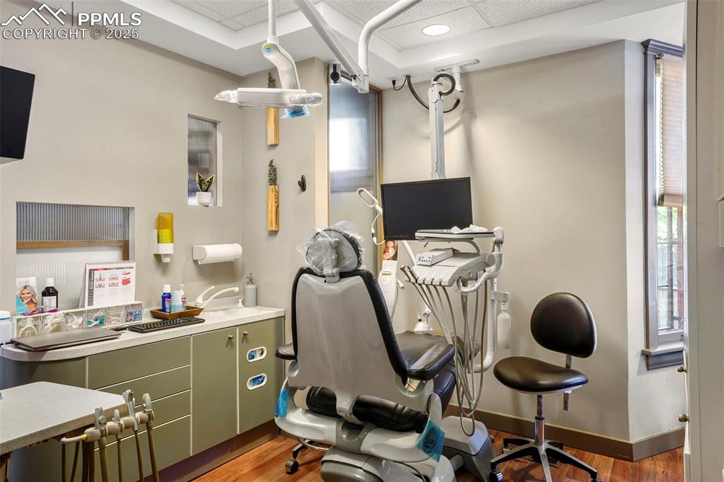 Image 14 of 28: Office area with light wood-style flooring and baseboards