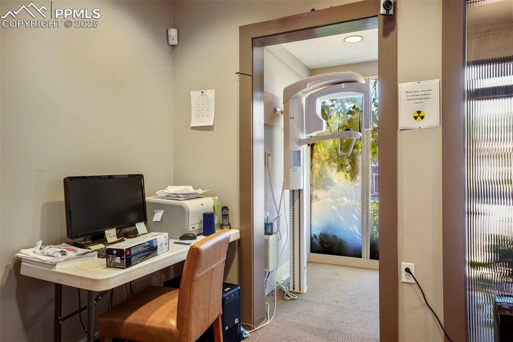 Image 16 of 28: Carpeted office with a heating unit