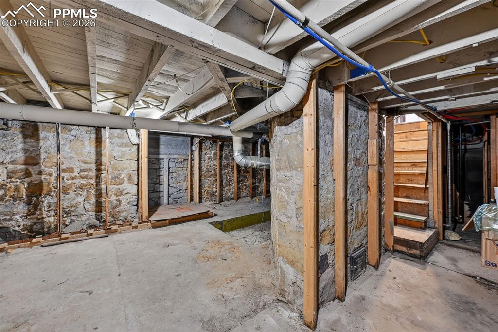 Image 17 of 34: Unfinished basement offers plenty of storage and room for expansion