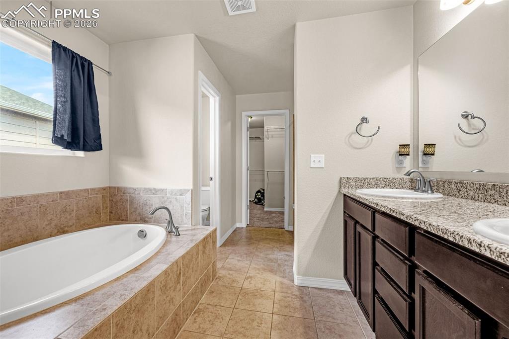 Image 24 of 37: 5 piece primary bathroom with walk in closet