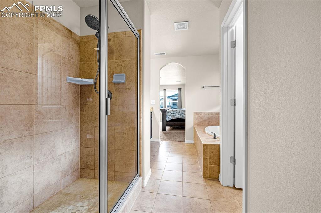 Image 26 of 37: 5 piece primary bathroom with walk in closet