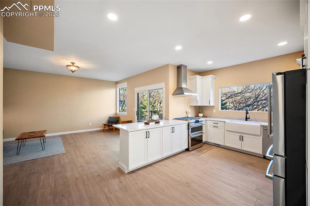 Image 11 of 50: Kitchen with a peninsula island, stainless steel Cafe appliances, newly ins