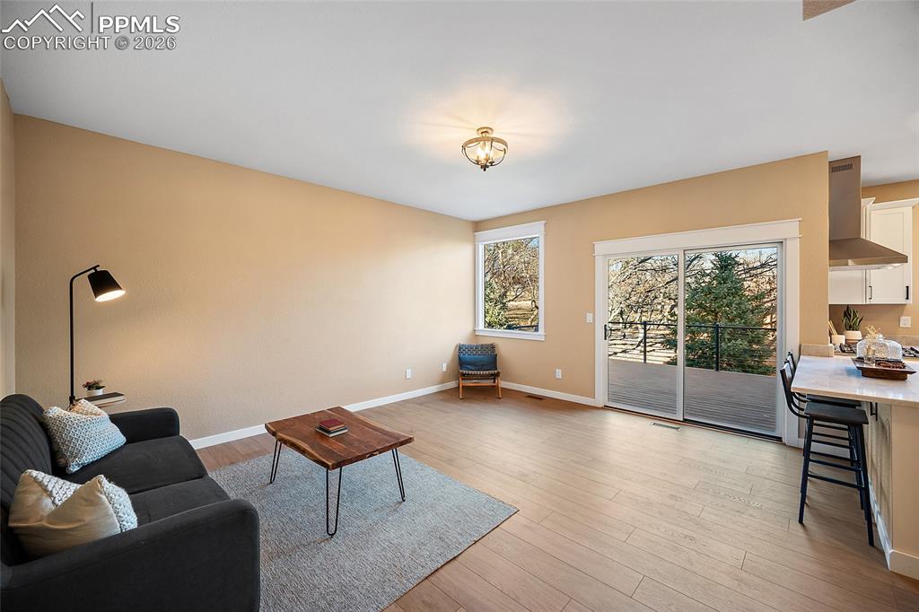 Image 14 of 50: Living room with walkout onto new Trex deck