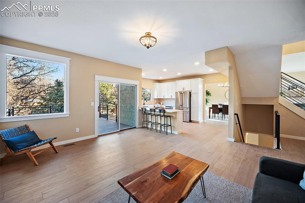 Image 15 of 50: View of living room, kitchen and walkout
