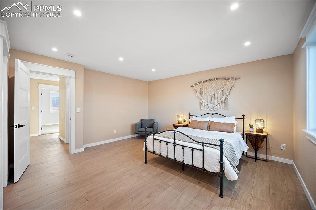 Image 21 of 50: Generously sized primary bedroom featuring abundant natural light