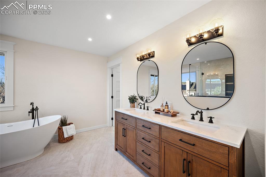 Image 23 of 50: Luxurious, spa inspired primary bath featuring double vanity, a freestandin