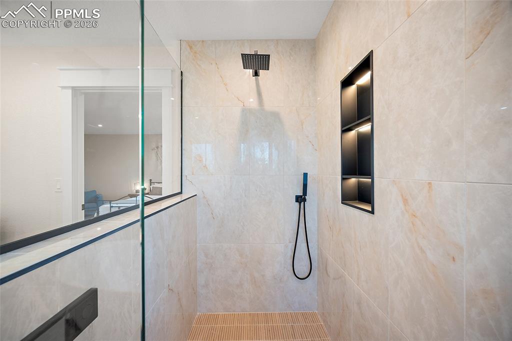 Image 25 of 50: Spa inspired shower with a Moen Smart Shower control system