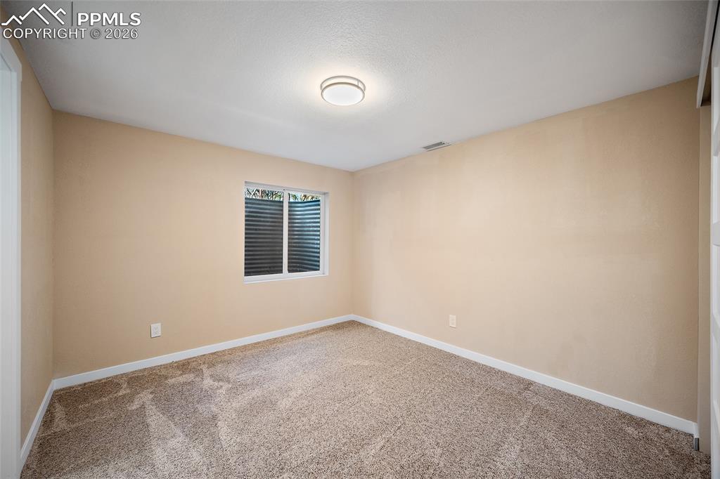 Image 38 of 50: Basement bedroom with ensuite bath