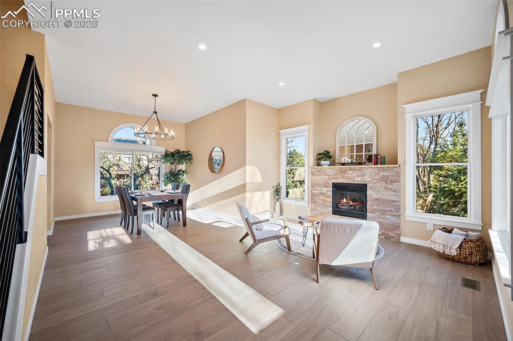 Image 4 of 50: Living area featuring abundant natural light, LVP flooring, high ceilings, 