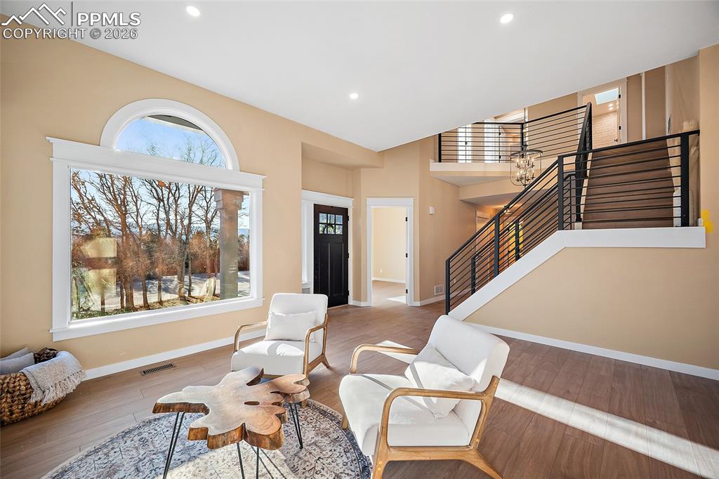 Image 7 of 50: Entry, living area, newly installed iron banisters