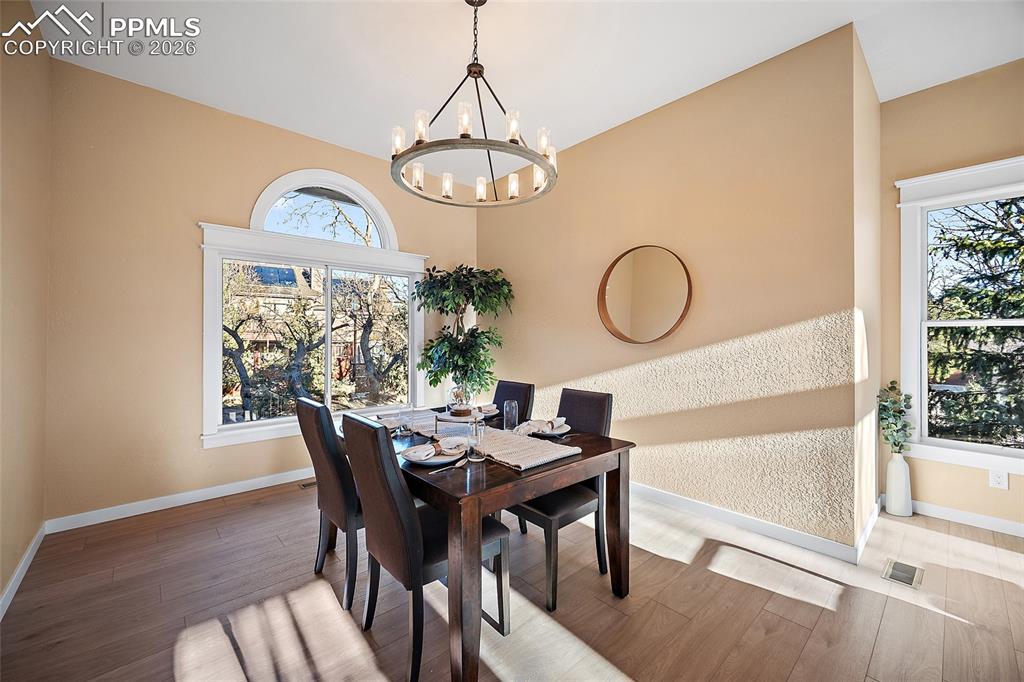 Image 9 of 50: Dining area featuring new LVP flooring and a new dining chandelier
