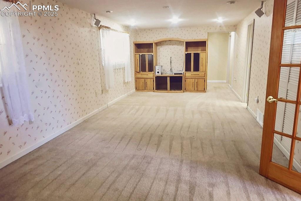 Image 26 of 50: Family Room with Built-In Bookshelves