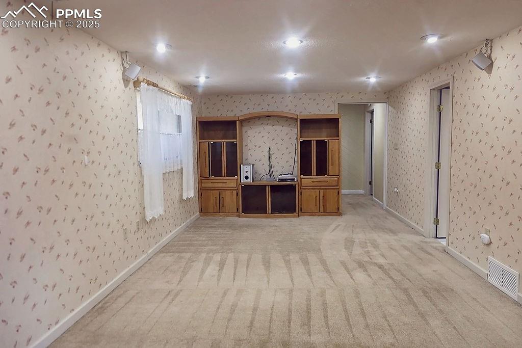 Image 27 of 50: Family Room with Built-In Bookshelves